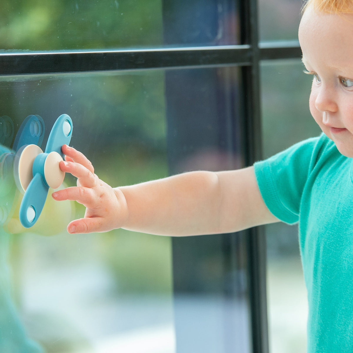 tickit spinner a elica azzurro in silicone alimentare, bottoni pop e base a ventosa